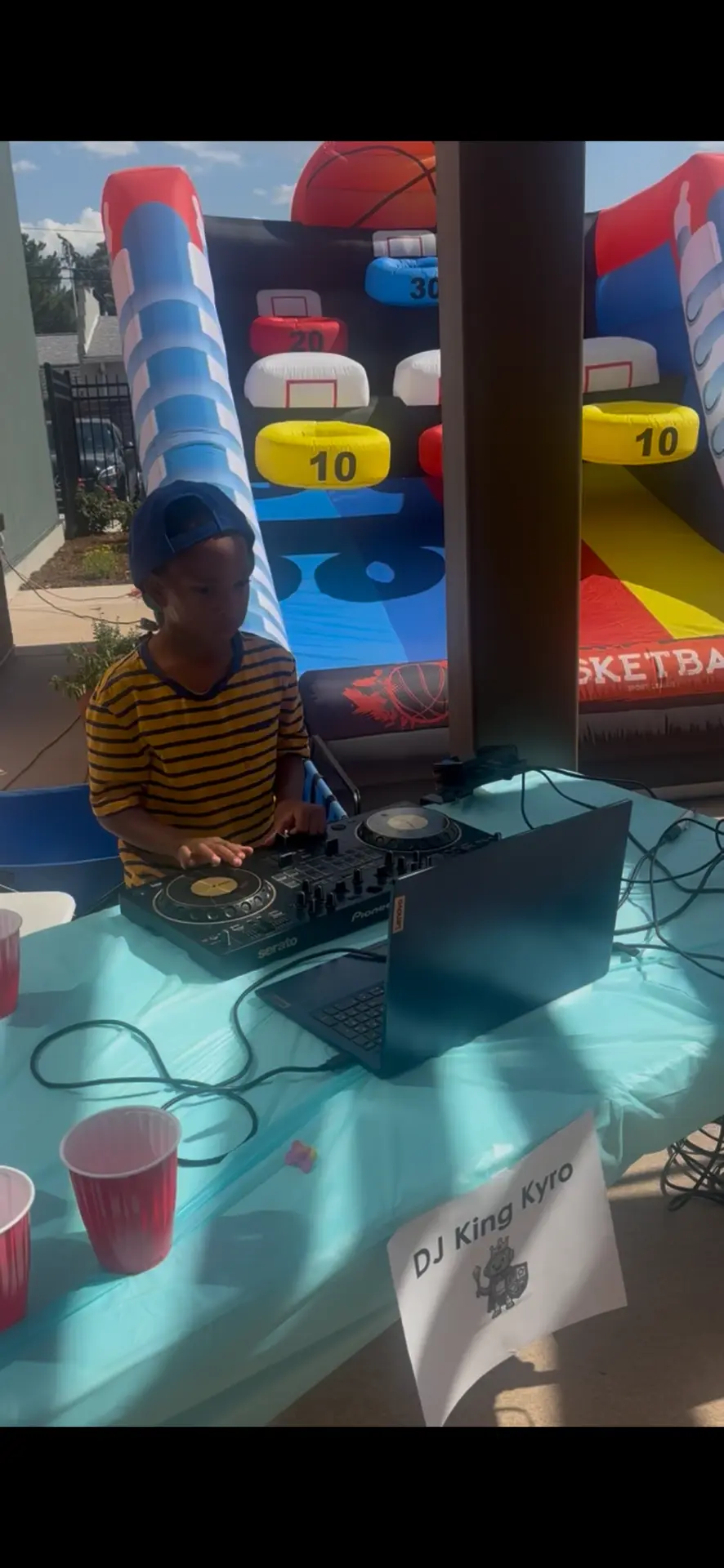 DJ King Kyro DJing at an outdoor birthday party